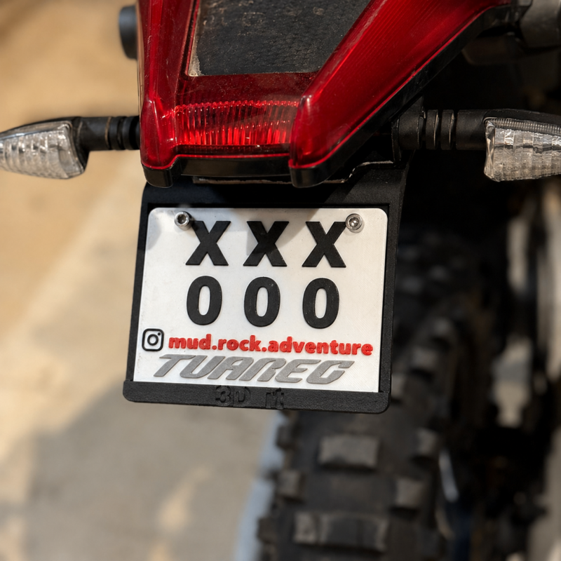 Custom 3D printed off-road motorcycle plate with XXX 000 design mounted on rear fender, close-up detail