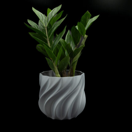 Grey 3D printed planter with textured spiral design on a modern console table in a moody interior