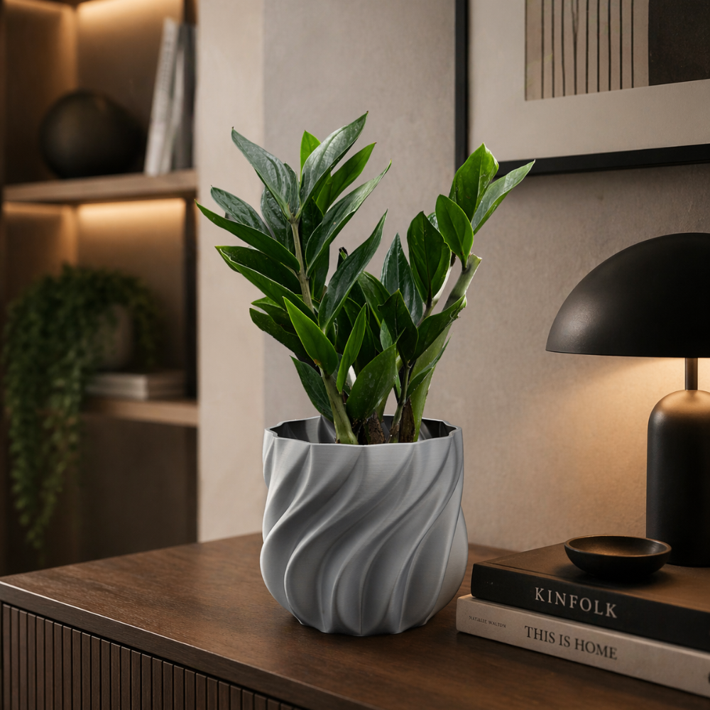 Grey 3D printed planter with textured spiral design on a modern console table in a moody interior