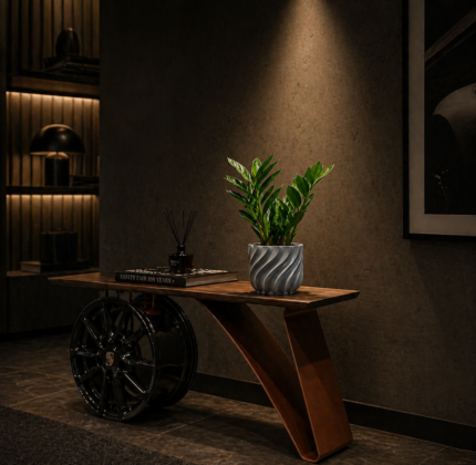 Grey 3D printed planter with textured spiral design on a modern console table in a moody interior