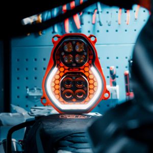 Custom KTM LED headlight by 3Dit with dual LED pods and DRL strip in workshop environment