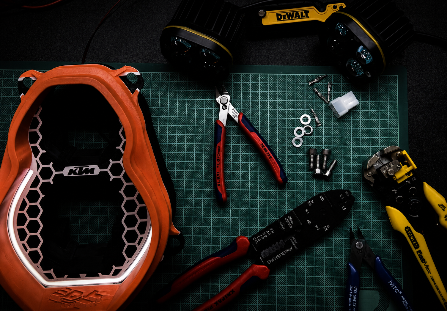 Custom KTM LED headlight by 3Dit with dual LED pods and DRL strip in workshop environment