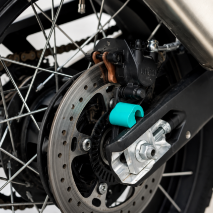 Close-up of the 3Dit CFMOTO 450MT rear ABS cover installed near the rear brake assembly and axle system.