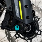Close-up of the 3Dit CFMOTO 450MT rear ABS cover installed near the rear brake assembly and axle system.