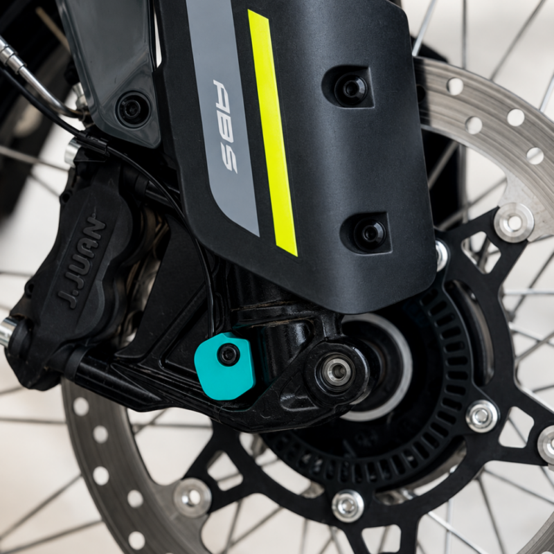 Close-up of the 3Dit CFMOTO 450MT rear ABS cover installed near the rear brake assembly and axle system.